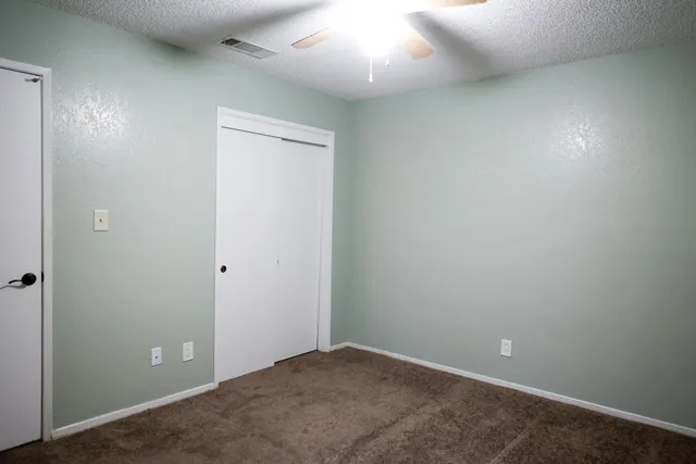 an empty room with closet area