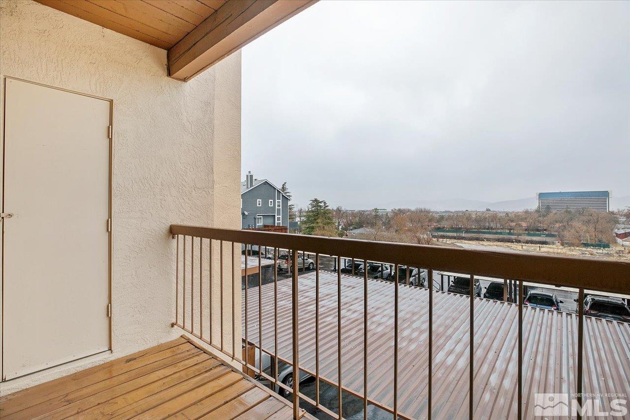 2750 Plumas Street, Unit 219 Reno, NV 89509 - Photo 14 of 22 a view of a balcony with wooden floor and fence
