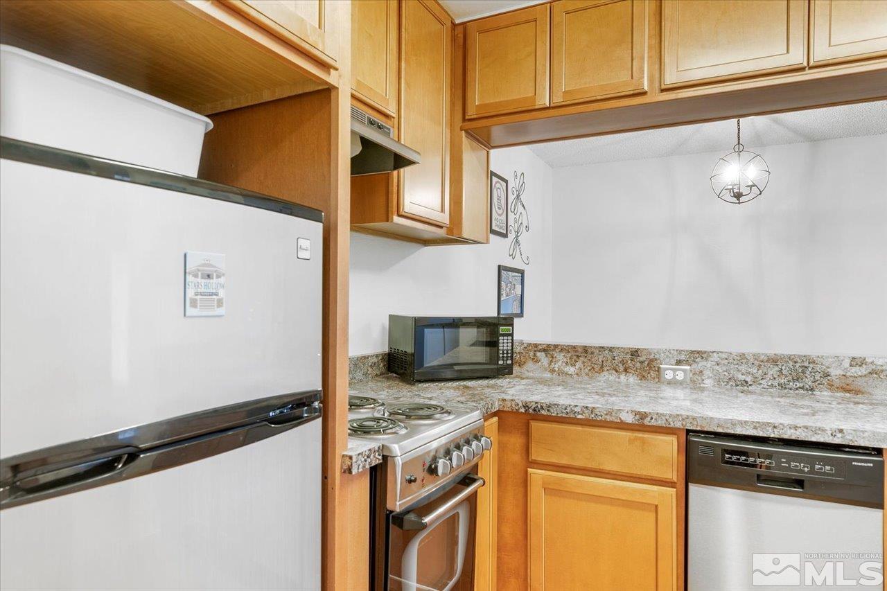 2750 Plumas Street, Unit 219 Reno, NV 89509 - Photo 2 of 22 a kitchen with granite countertop cabinets stainless steel appliances and a counter space