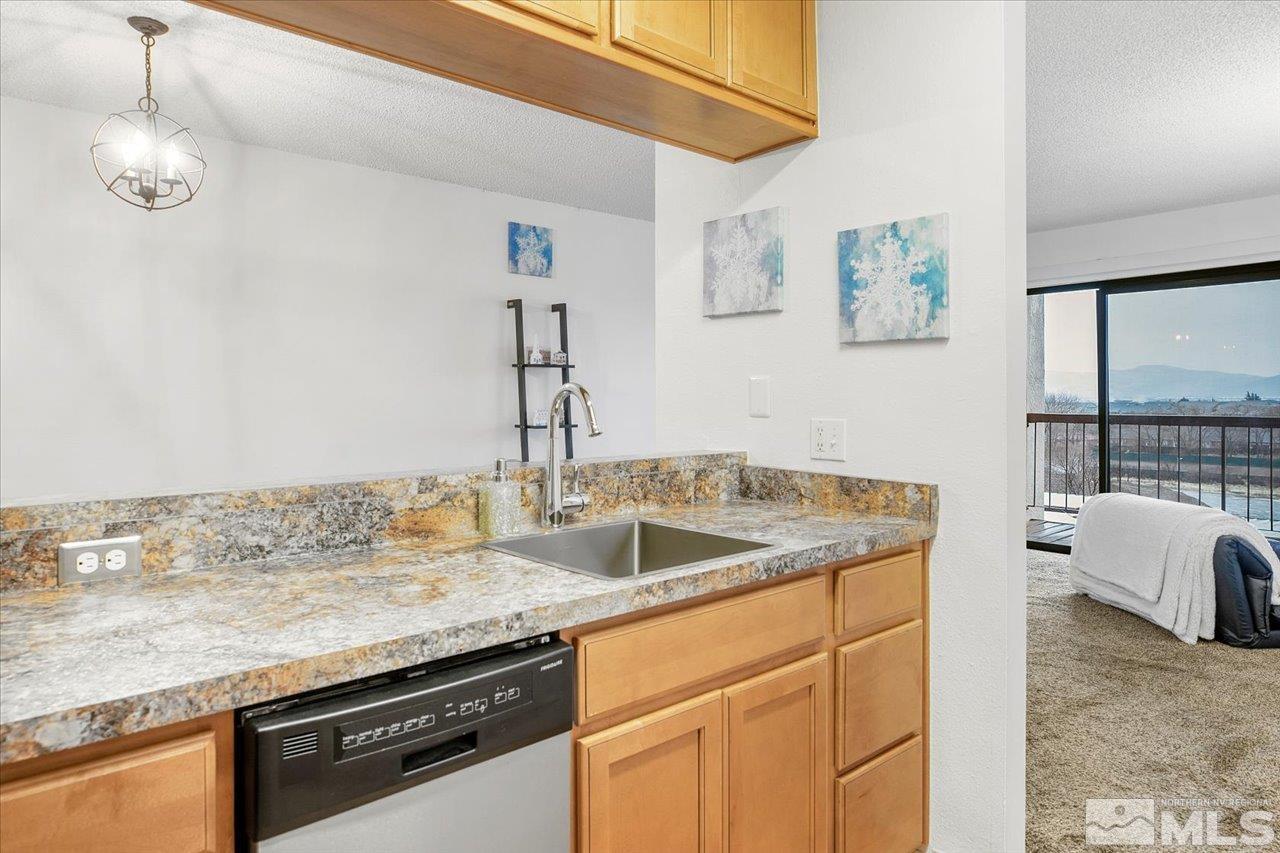 2750 Plumas Street, Unit 219 Reno, NV 89509 - Photo 3 of 22 a kitchen with granite countertop a sink and a stove