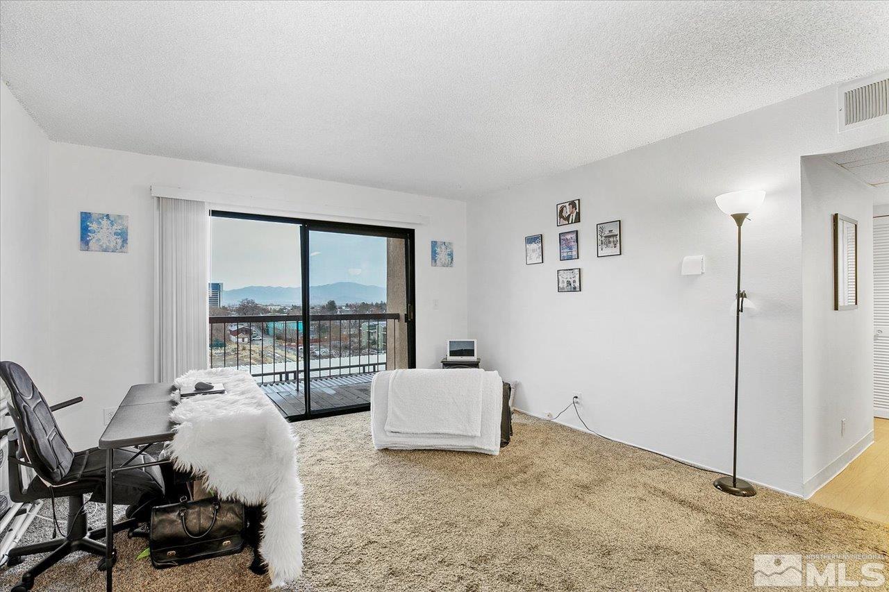 2750 Plumas Street, Unit 219 Reno, NV 89509 - Photo 5 of 22 a living room with furniture and a floor to ceiling window