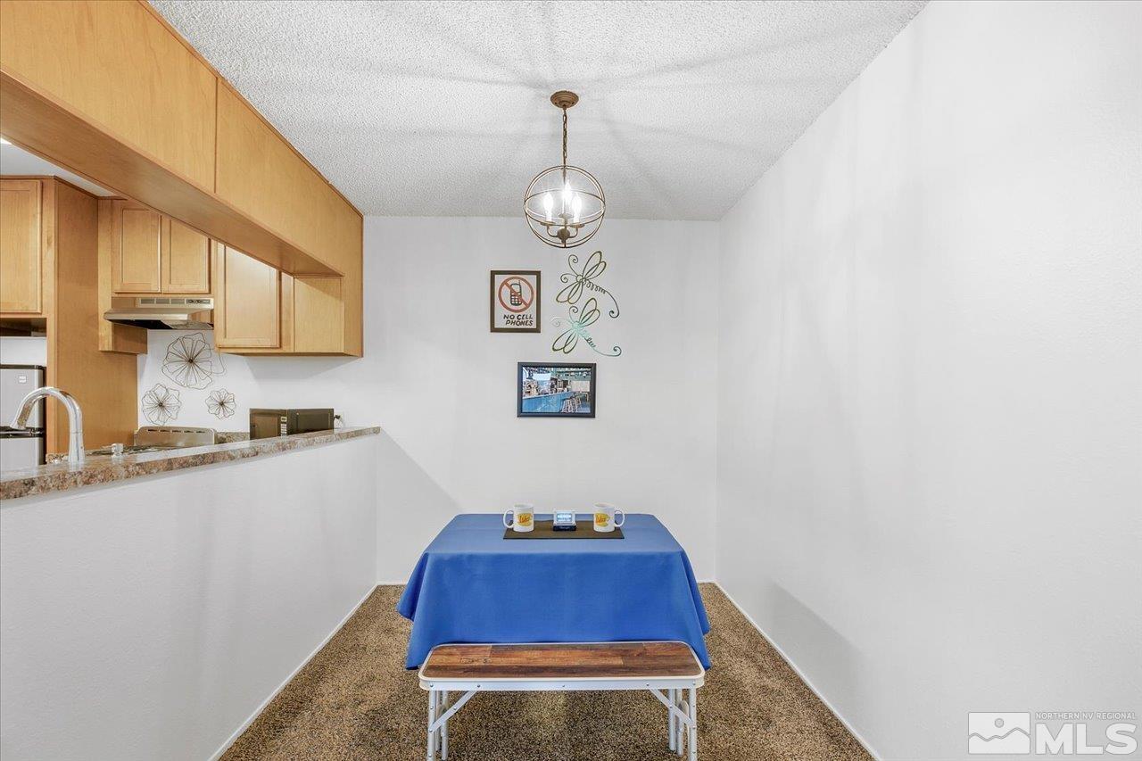 2750 Plumas Street, Unit 219 Reno, NV 89509 - Photo 8 of 22 a kitchen with stainless steel appliances granite countertop a sink window and cabinets