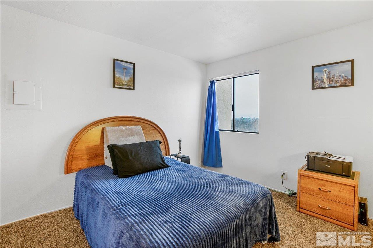 2750 Plumas Street, Unit 219 Reno, NV 89509 - Photo 9 of 22 a bedroom with a bed and a mirror