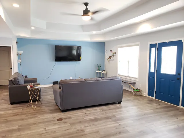 a living room with furniture and a flat screen tv