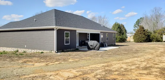 a view of a house with snow in the yard