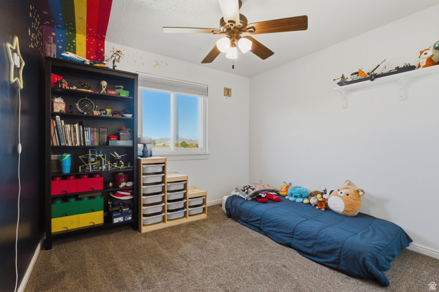 11189 Ohenry Road East Sandy, UT 84070 - Photo 18 of 44 Bedroom featuring neutral carpeting, a large window, a ceiling fan with integrated lighting, and white walls
