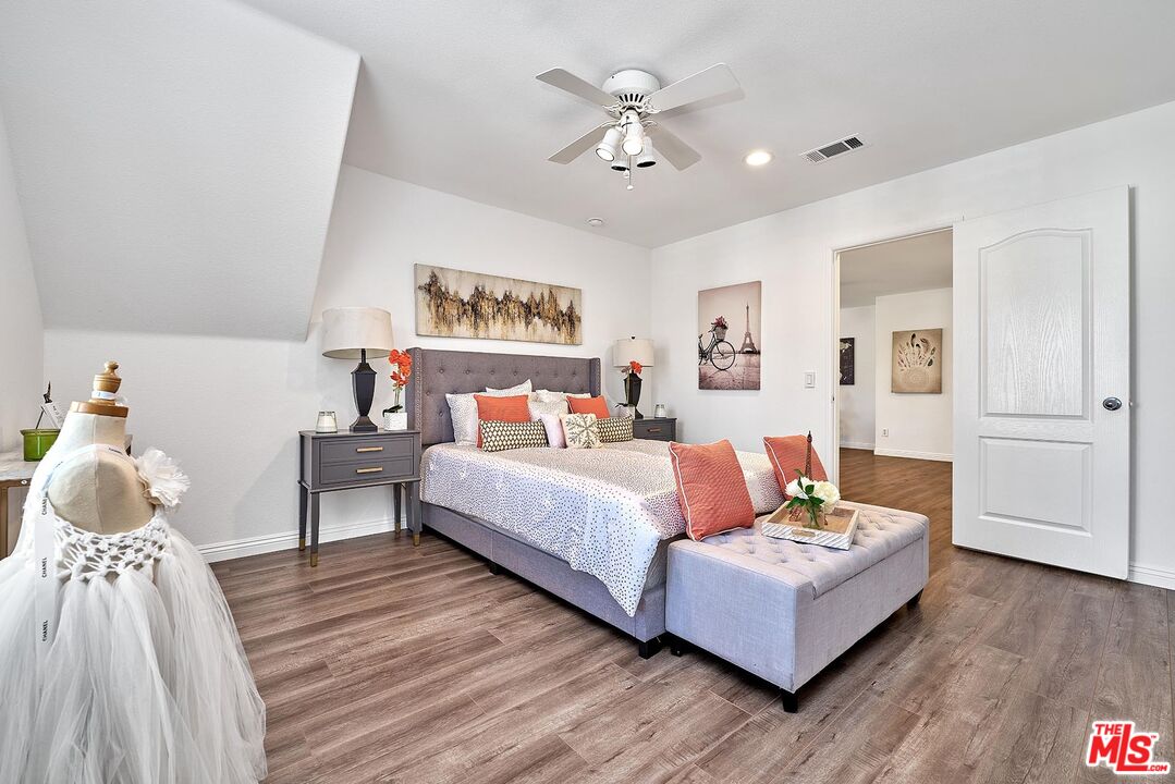 38 Windward Way Buena Park, CA 90621 - Photo 31 of 71 a bedroom with a bed and a chandelier