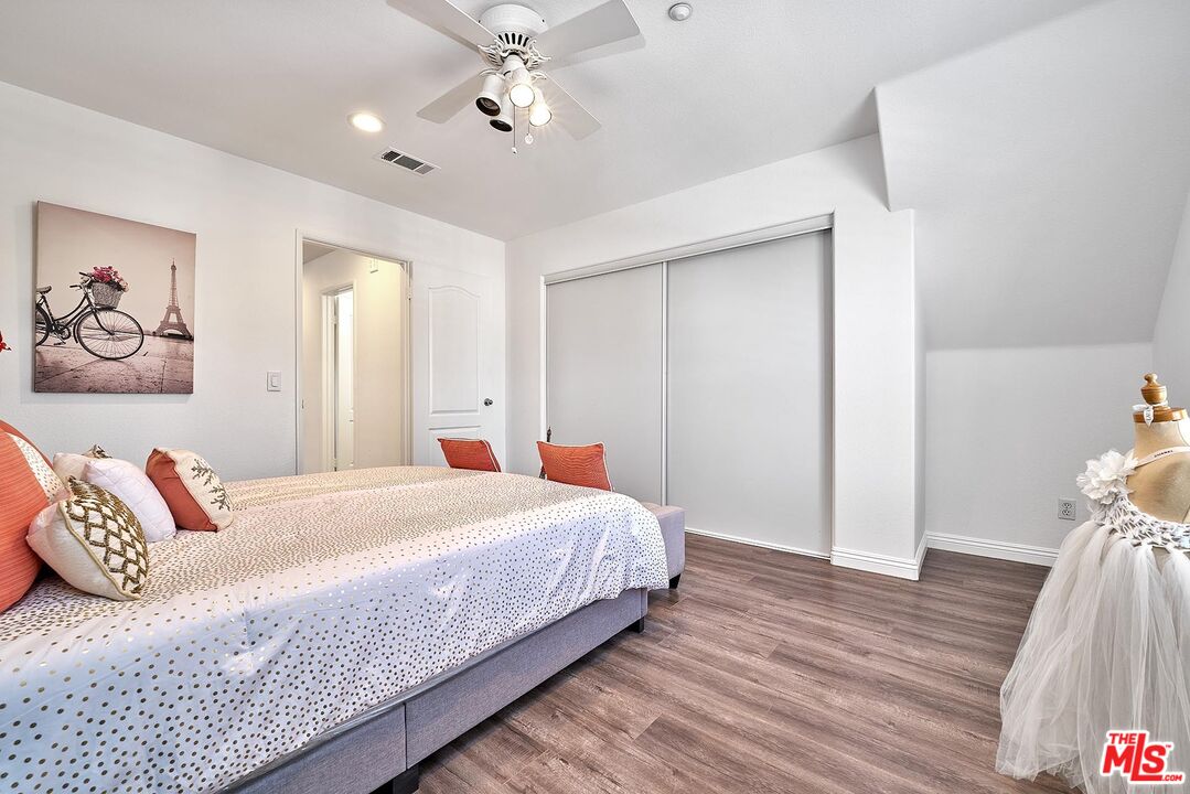 38 Windward Way Buena Park, CA 90621 - Photo 32 of 71 a bedroom with a large bed and a chandelier