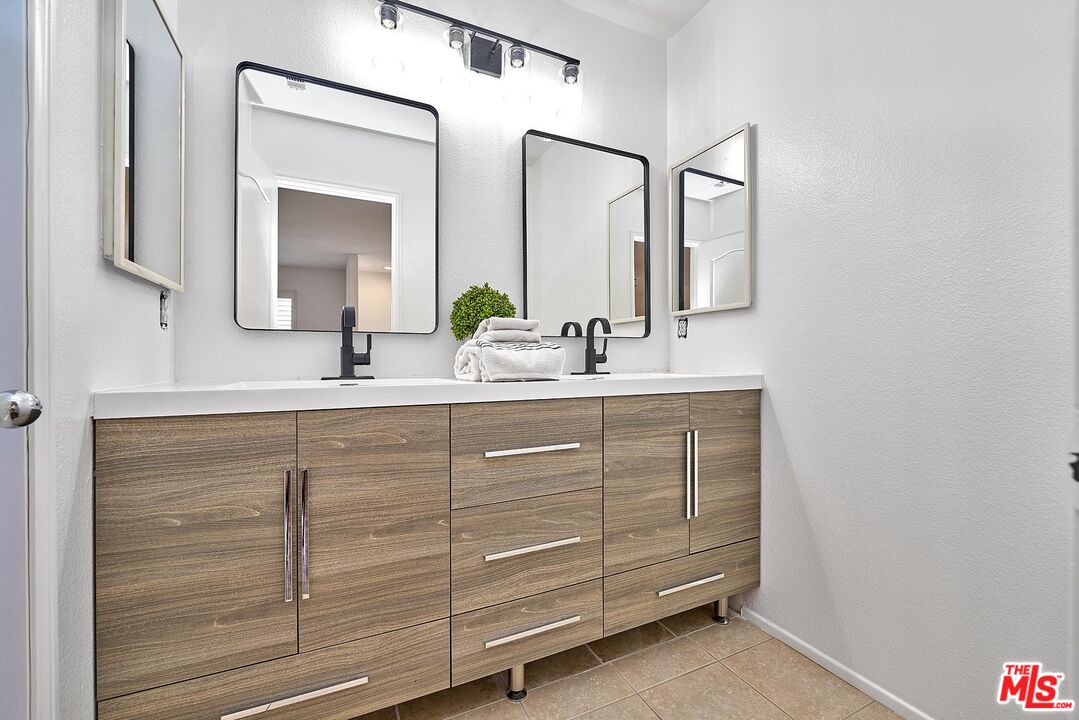 38 Windward Way Buena Park, CA 90621 - Photo 33 of 71 a bathroom with a double vanity sink and a mirror