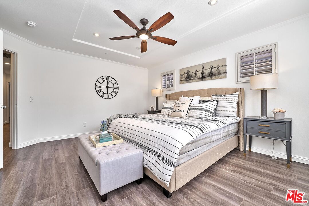 38 Windward Way Buena Park, CA 90621 - Photo 41 of 71 a bedroom with a large bed a lamp and a window