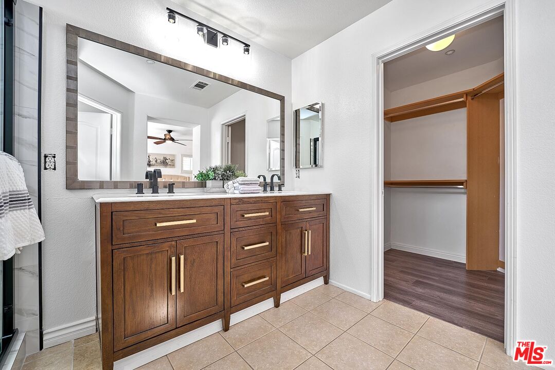 38 Windward Way Buena Park, CA 90621 - Photo 46 of 71 a bathroom with a granite countertop sink vanity and mirror