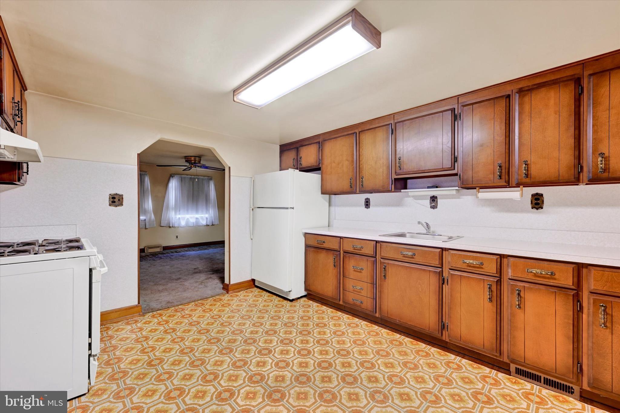 7437 New Cut Road Kingsville, MD 21087 - Photo 11 of 56 a kitchen with stainless steel appliances a refrigerator sink and wooden cabinets