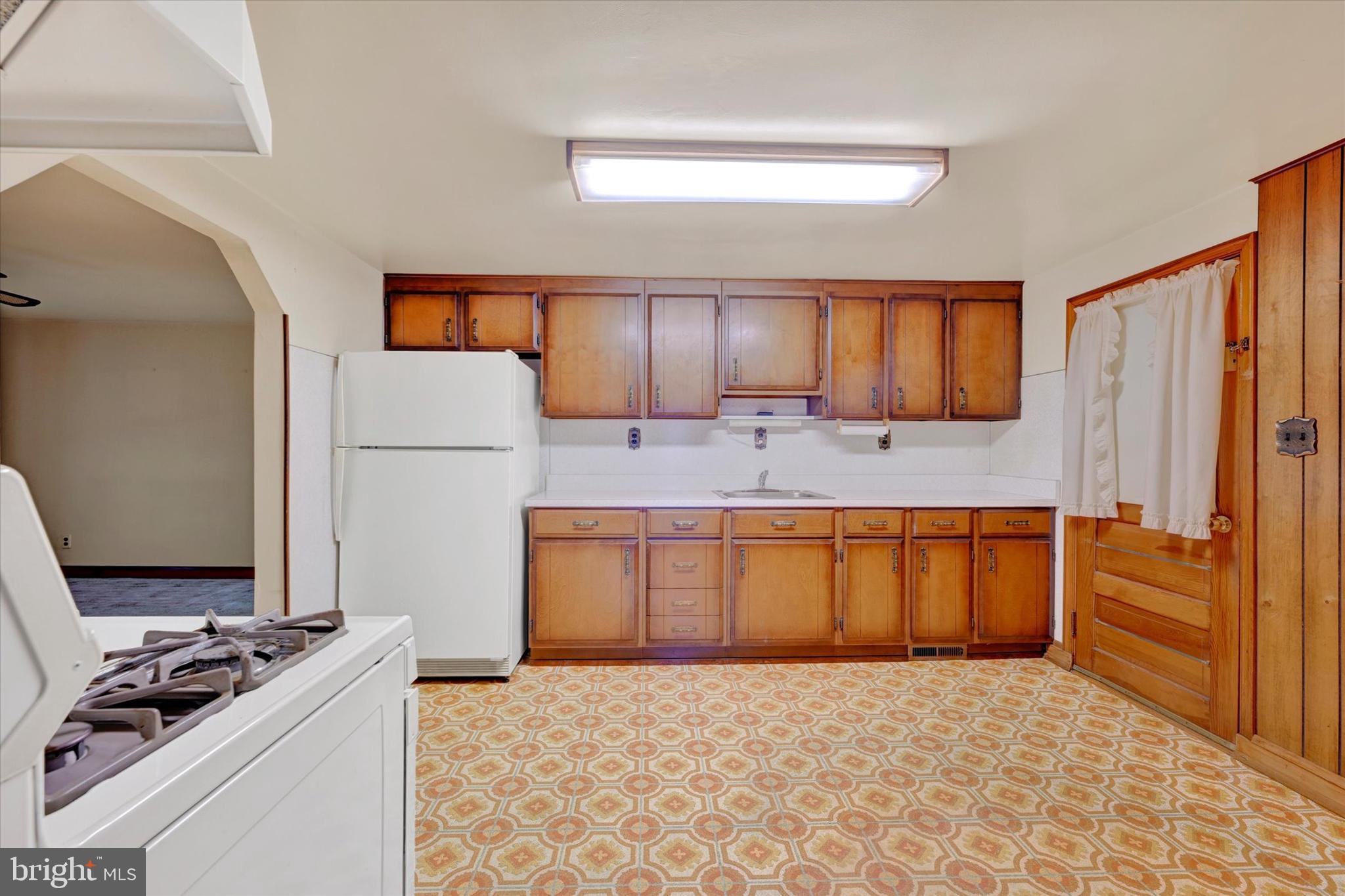 7437 New Cut Road Kingsville, MD 21087 - Photo 12 of 56 a kitchen with stainless steel appliances granite countertop a sink stove and refrigerator