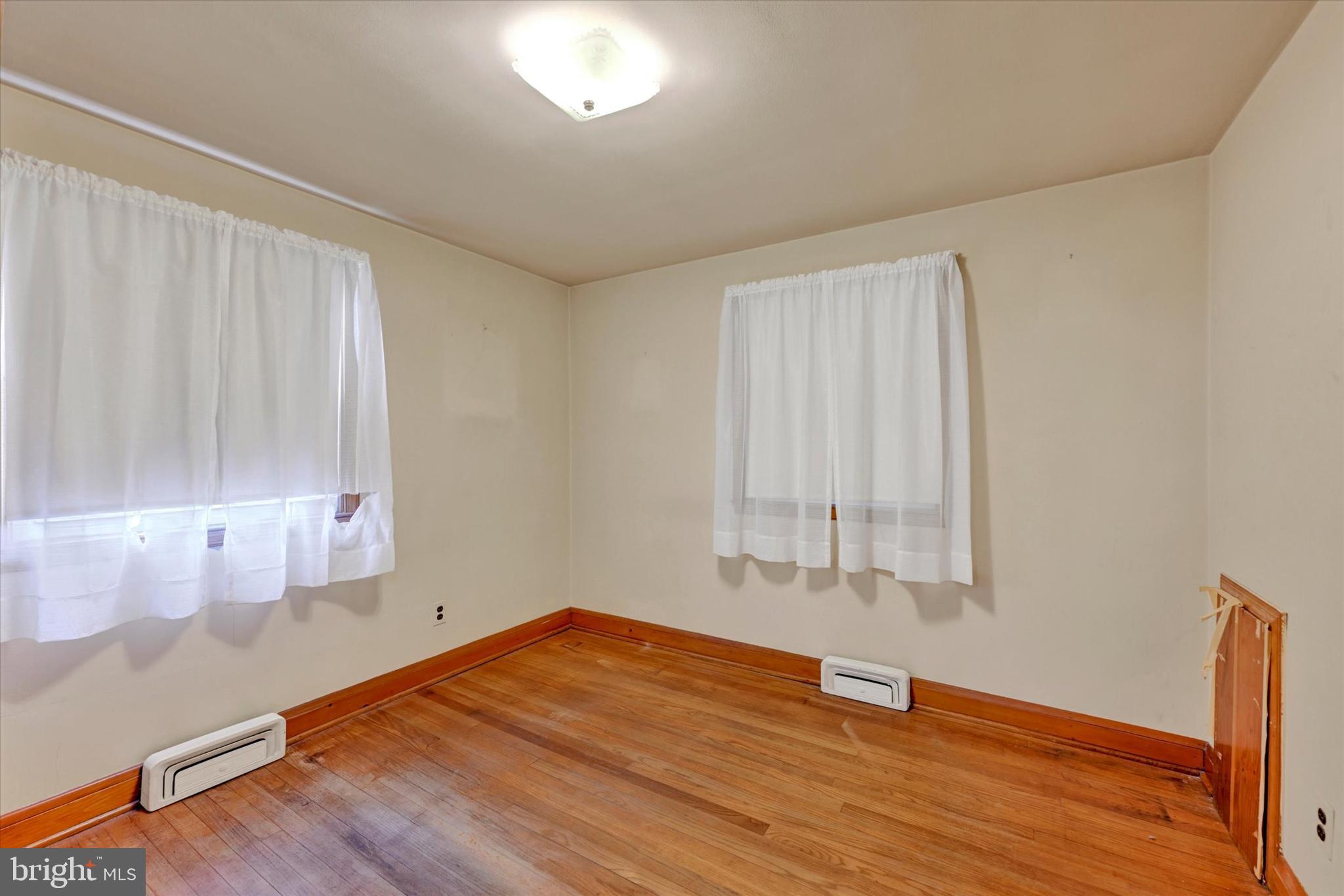 7437 New Cut Road Kingsville, MD 21087 - Photo 15 of 56 a view of an empty room with wooden floor and a window