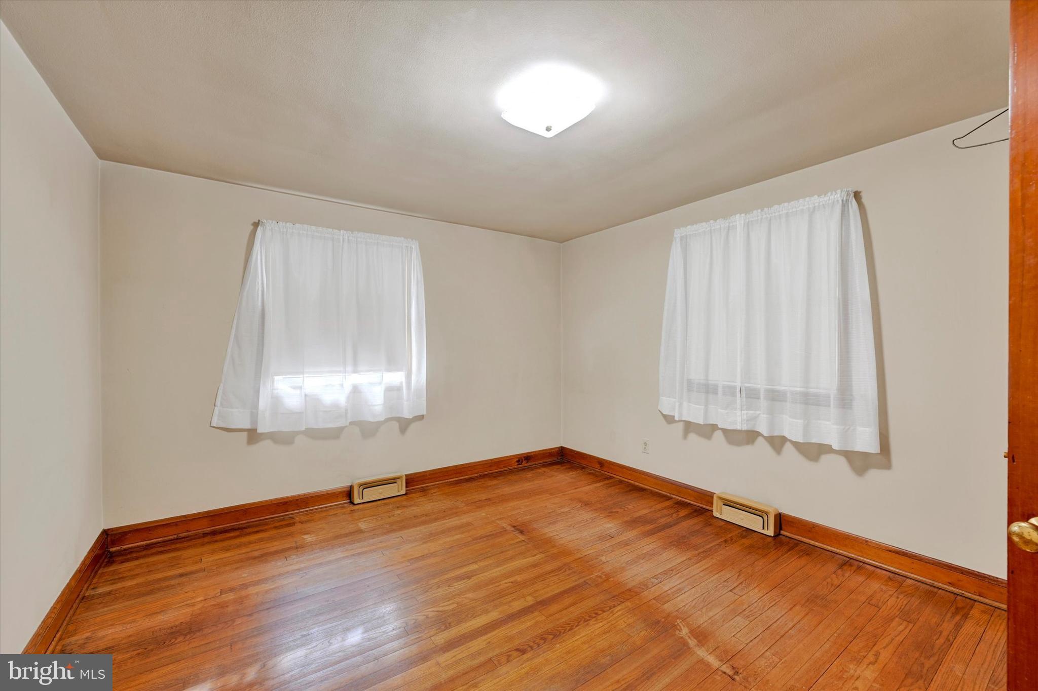 7437 New Cut Road Kingsville, MD 21087 - Photo 16 of 56 an empty room with wooden floor and windows