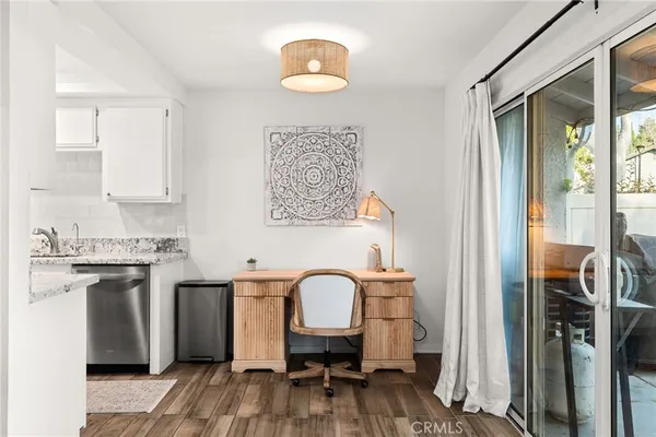 a workspace with wooden floor and a bathroom