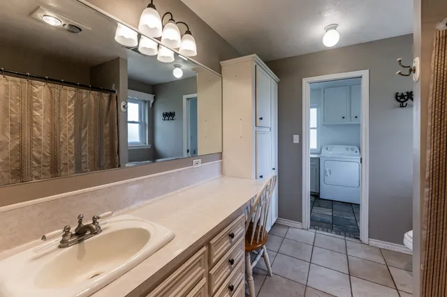 a bathroom with a sink a vanity and a mirror