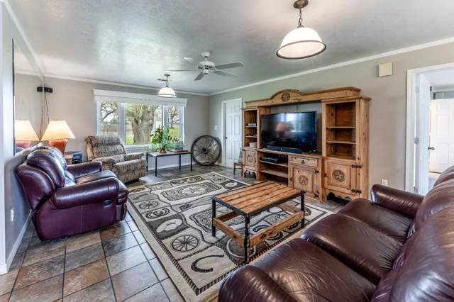 a living room with furniture a large window and a flat screen tv