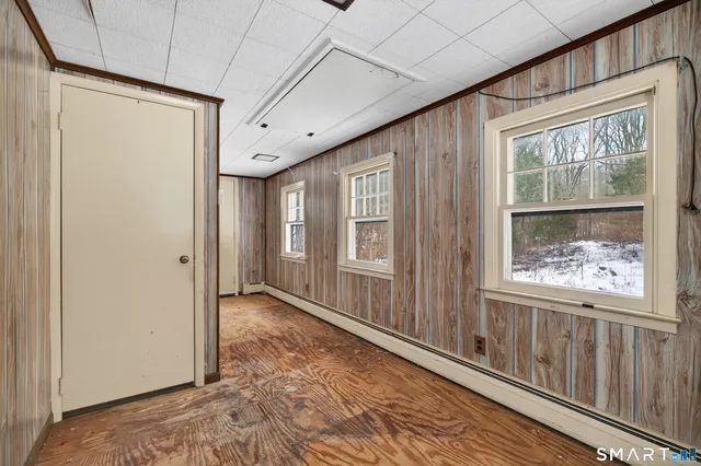 a view of a large room with wooden floor and windows