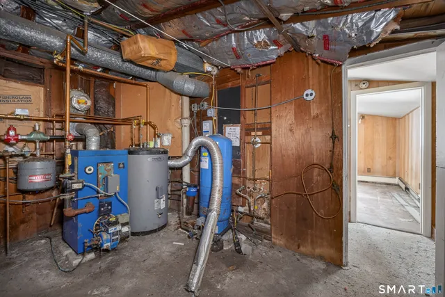 a view of white house with a yard covered in snow