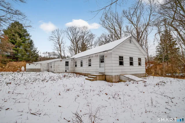 a large tree in front of a house