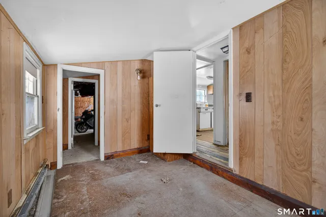a view of a hallway with wooden shelves
