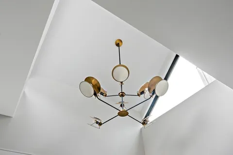 a picture of a room with a fan and wooden floor