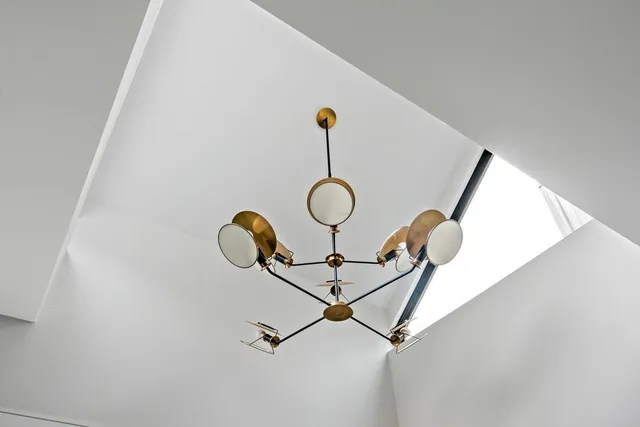 a picture of a room with a fan and wooden floor