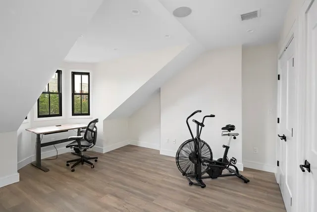 a view of a workspace with wooden floor