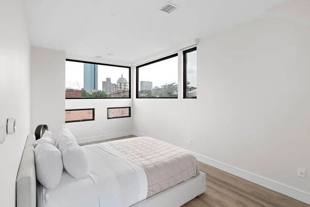 a bedroom with a bed and a window