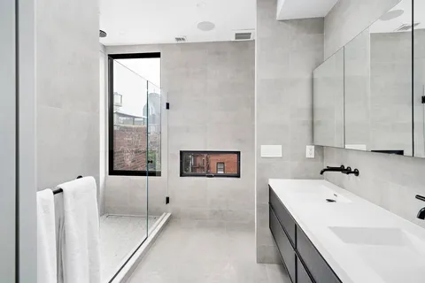 a bathroom with a tub sink and mirror
