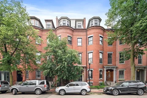 a picture of a bench in front of a wall