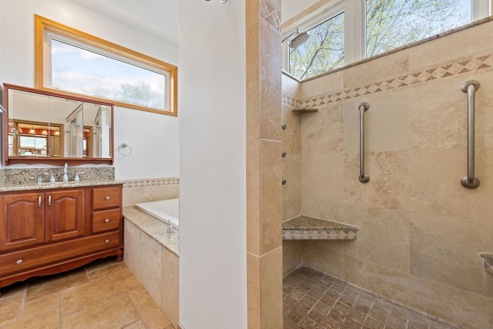 696 Lombardy Lane Deerfield, IL 60015 - Photo 11 of 26 a bathroom with a granite countertop sink a mirror and shower