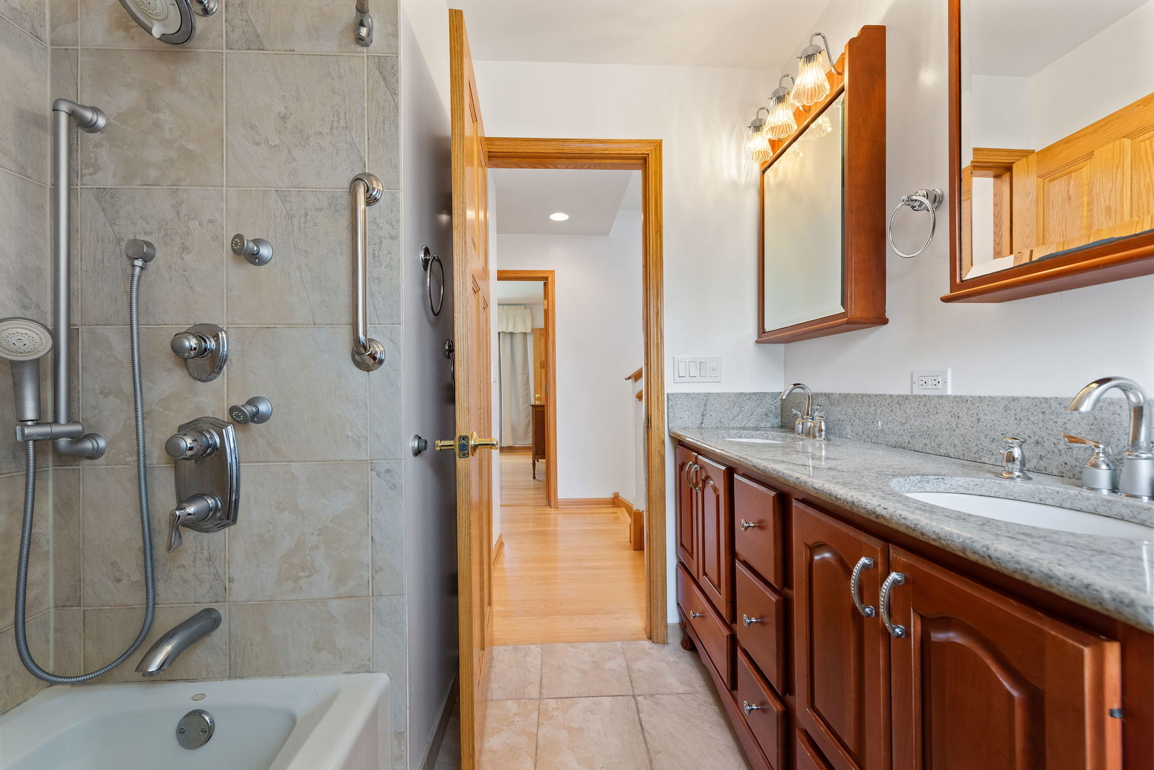 696 Lombardy Lane Deerfield, IL 60015 - Photo 15 of 26 a bathroom with a granite countertop sink mirror and shower