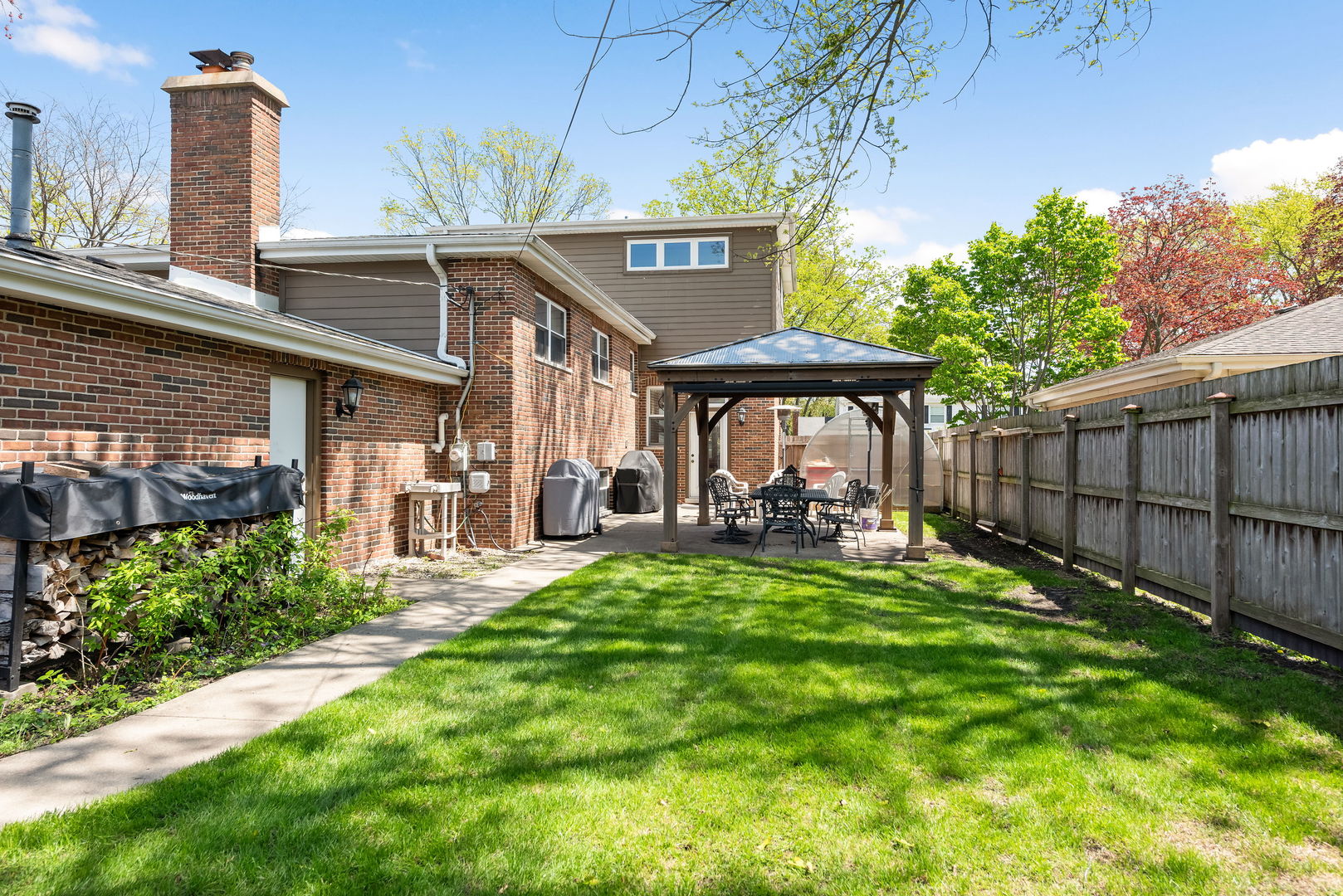 696 Lombardy Lane Deerfield, IL 60015 - Photo 21 of 26 a view of a chair and table in backyard of the house