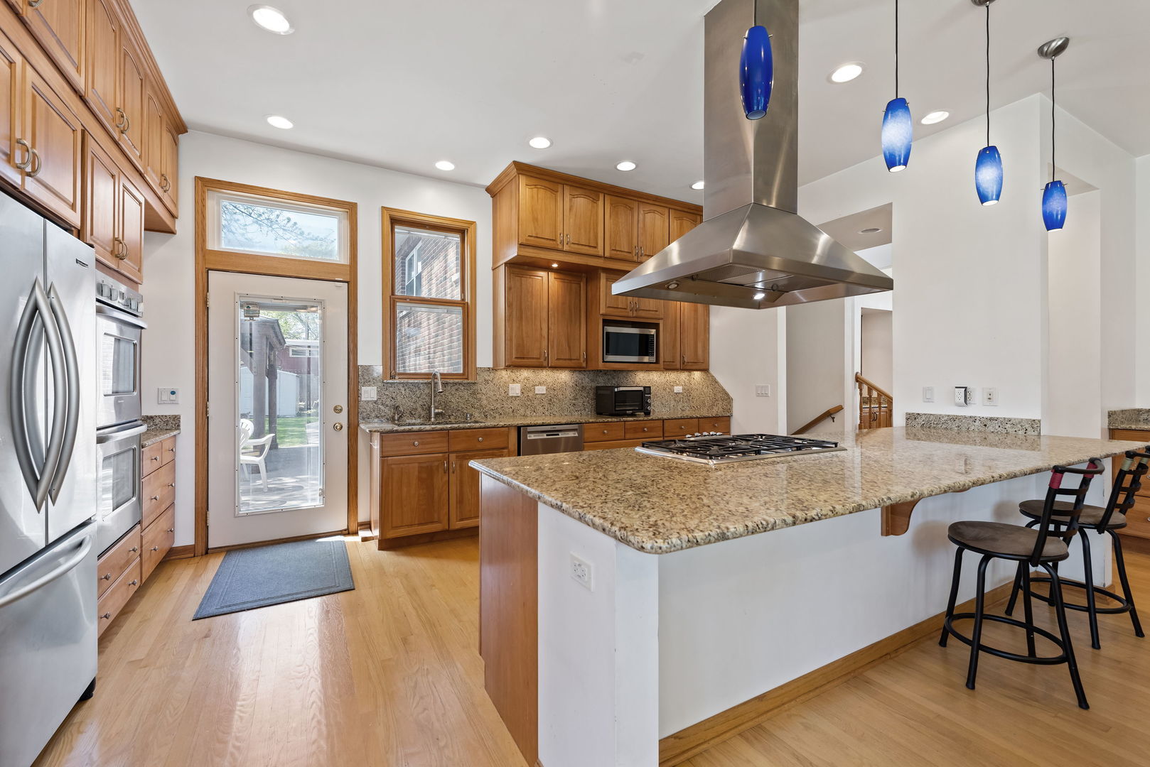 696 Lombardy Lane Deerfield, IL 60015 - Photo 6 of 26 a kitchen with stainless steel appliances granite countertop a stove and a sink