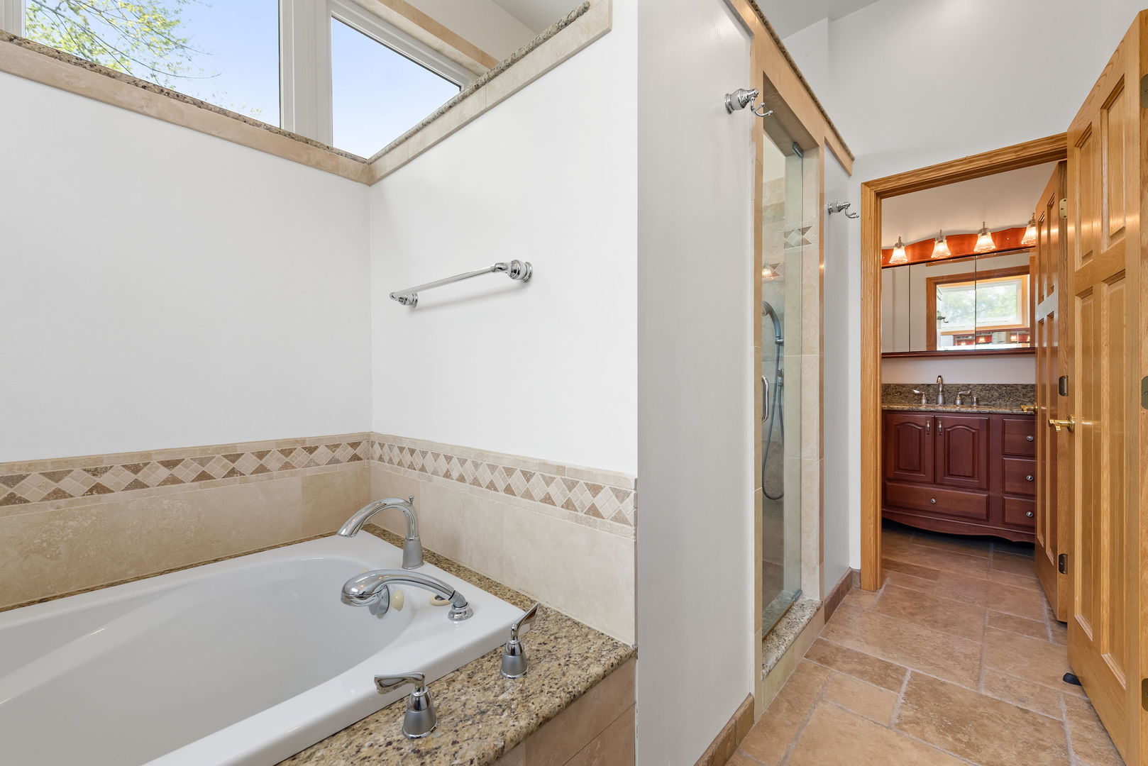 696 Lombardy Lane Deerfield, IL 60015 - Photo 10 of 26 a bathroom with a tub a sink and a window