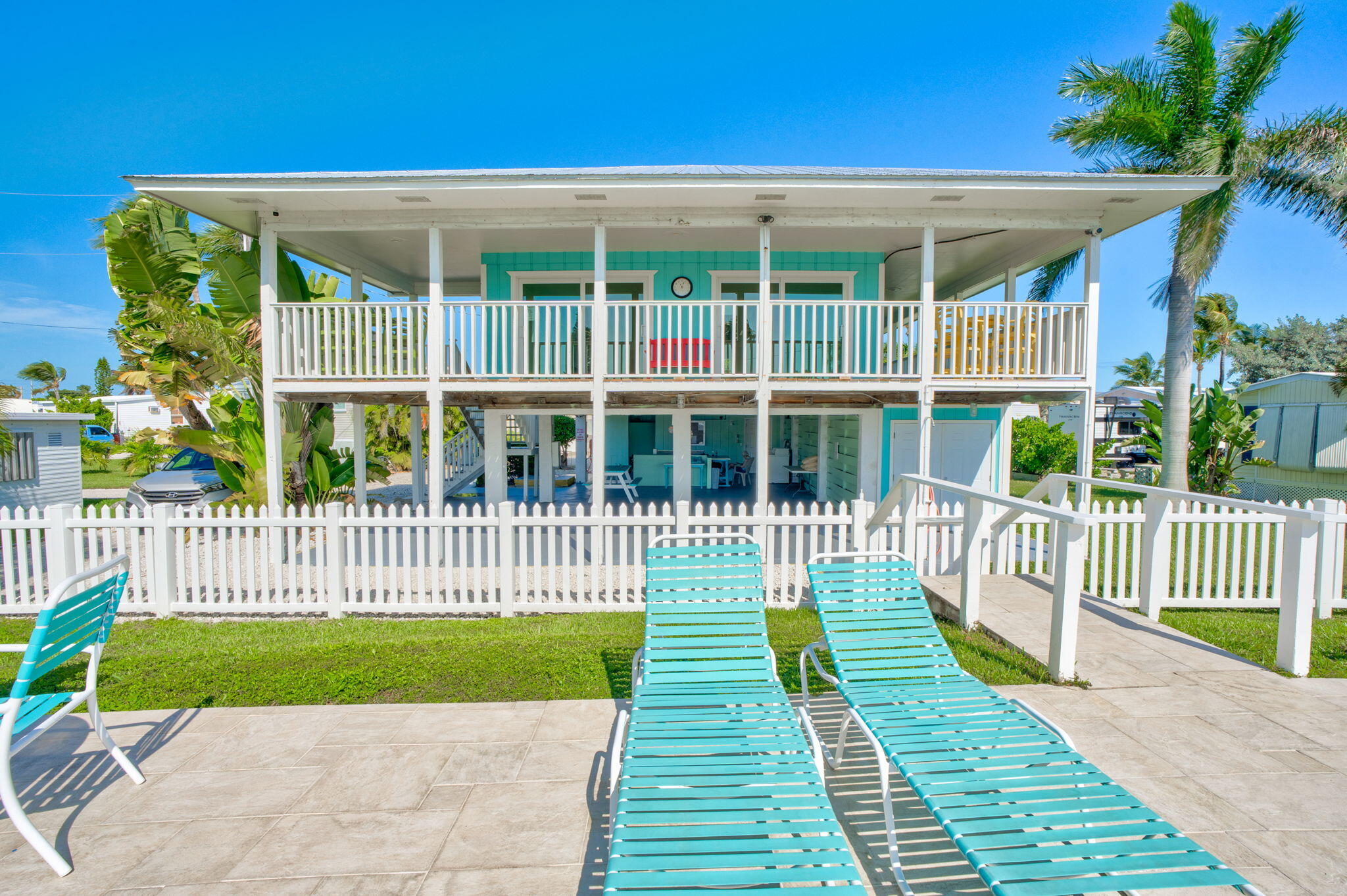 55 Boca Chica Road, Unit 53 Key West, FL 33040 - Photo 25 of 35 a view of a deck with a floor to ceiling window and wooden fence