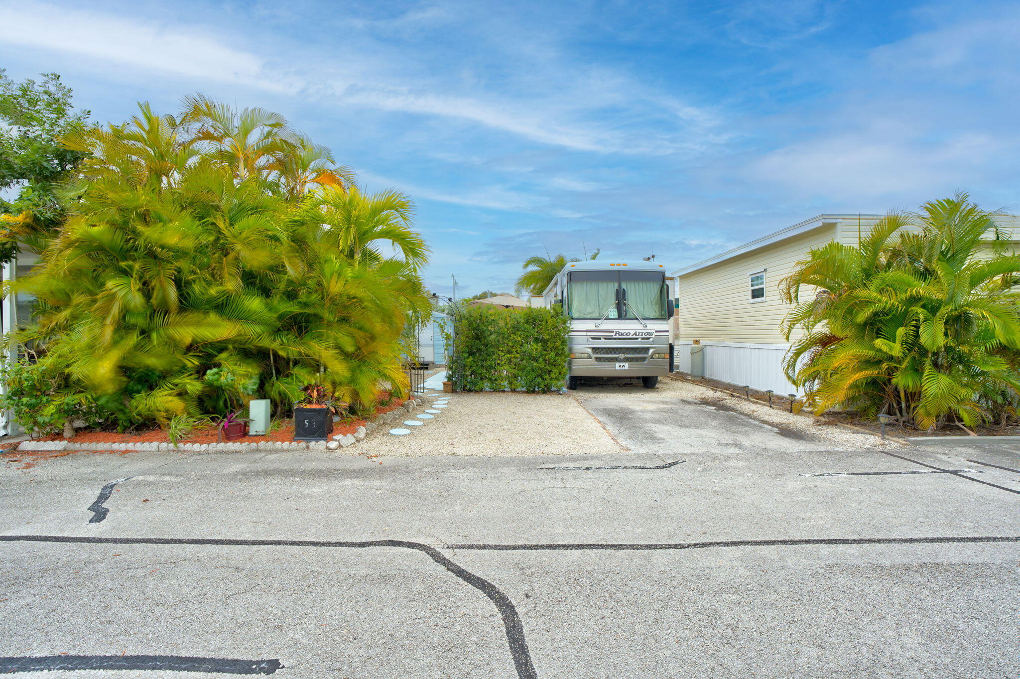 55 Boca Chica Road, Unit 53 Key West, FL 33040 - Photo 7 of 35 a front view of a house with a yard and plant