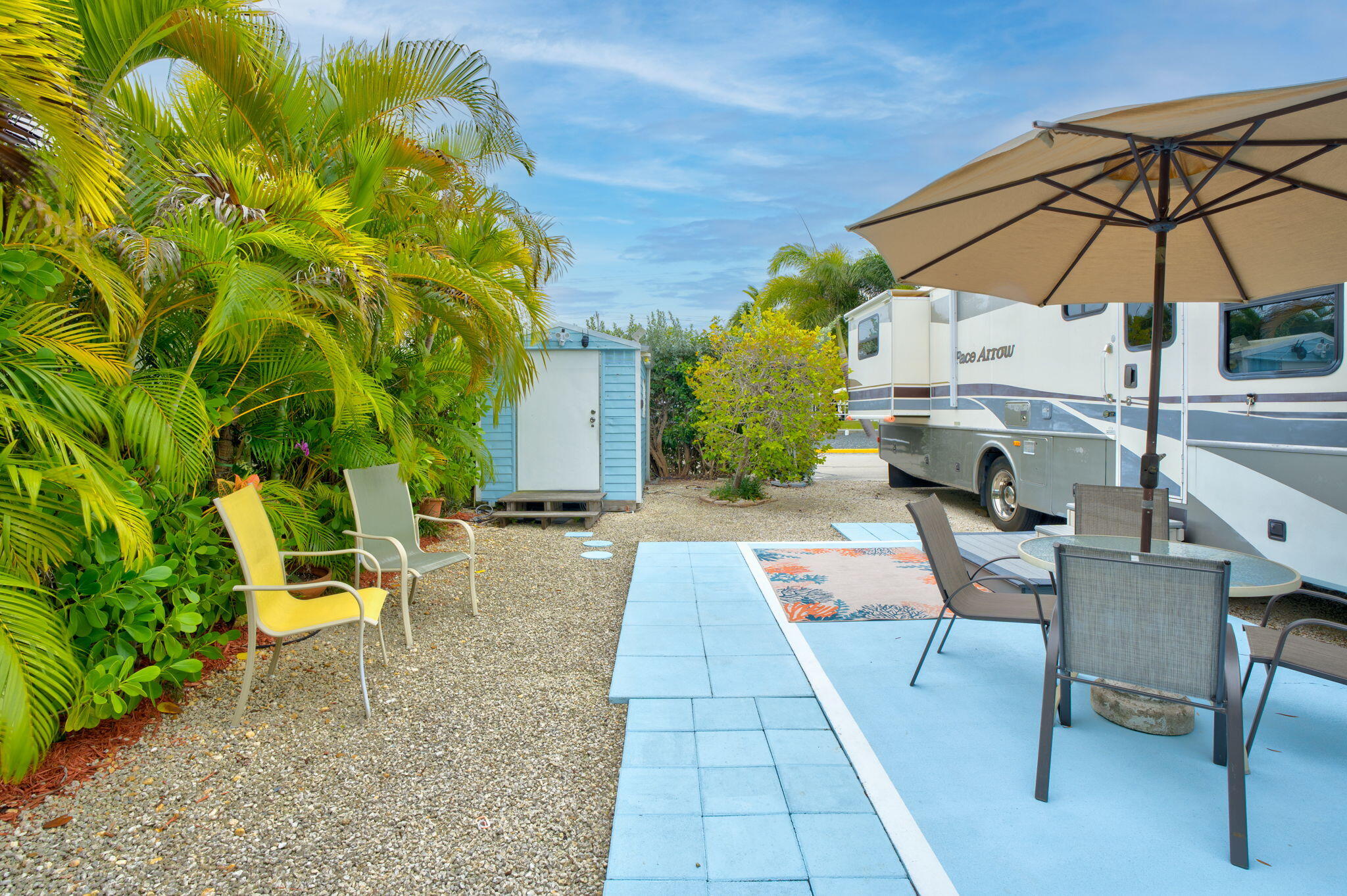 55 Boca Chica Road, Unit 53 Key West, FL 33040 - Photo 9 of 35 a view of a patio with a table and chairs under an umbrella