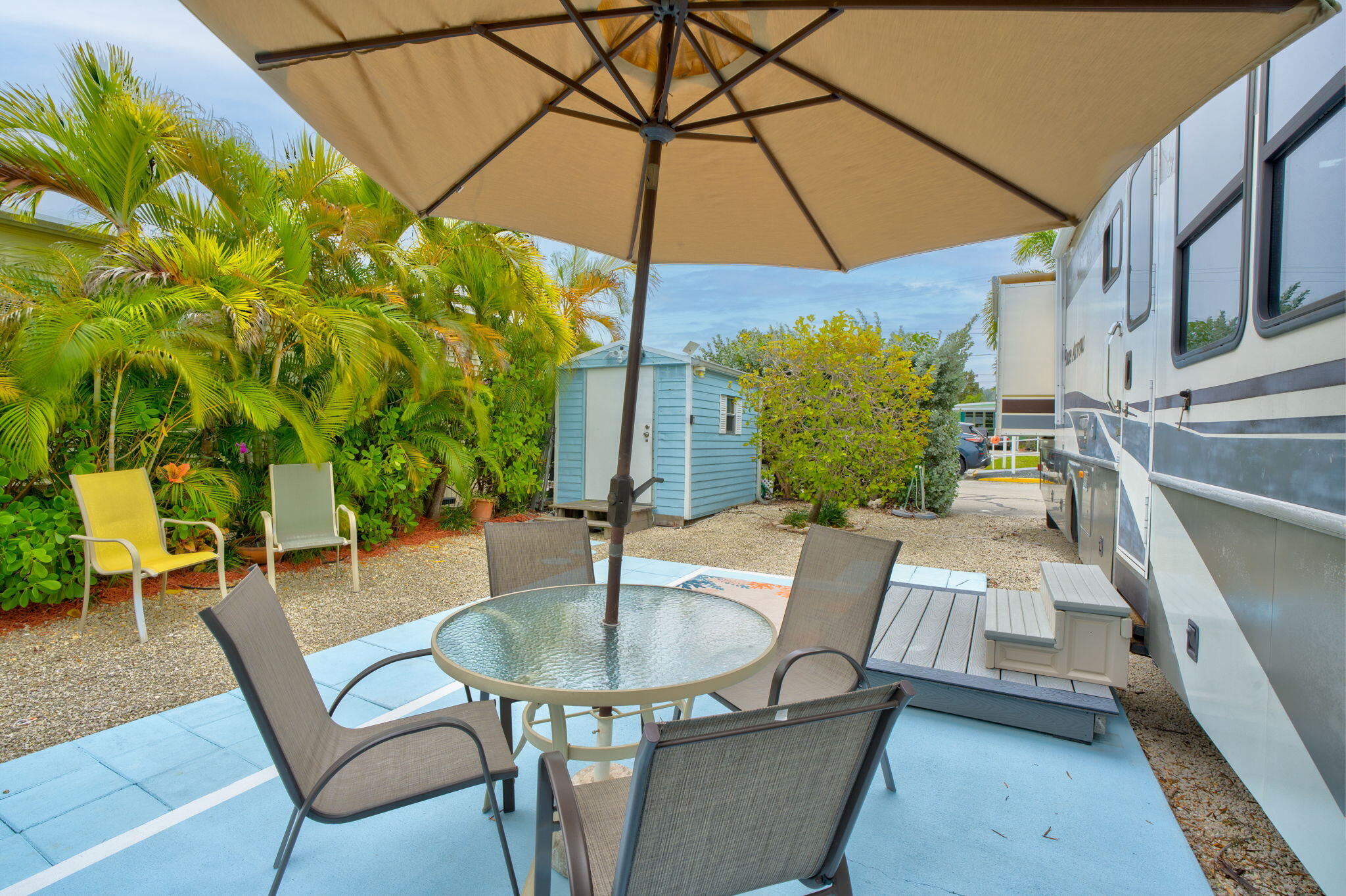 55 Boca Chica Road, Unit 53 Key West, FL 33040 - Photo 10 of 35 a view of a patio with table and chairs under an umbrella
