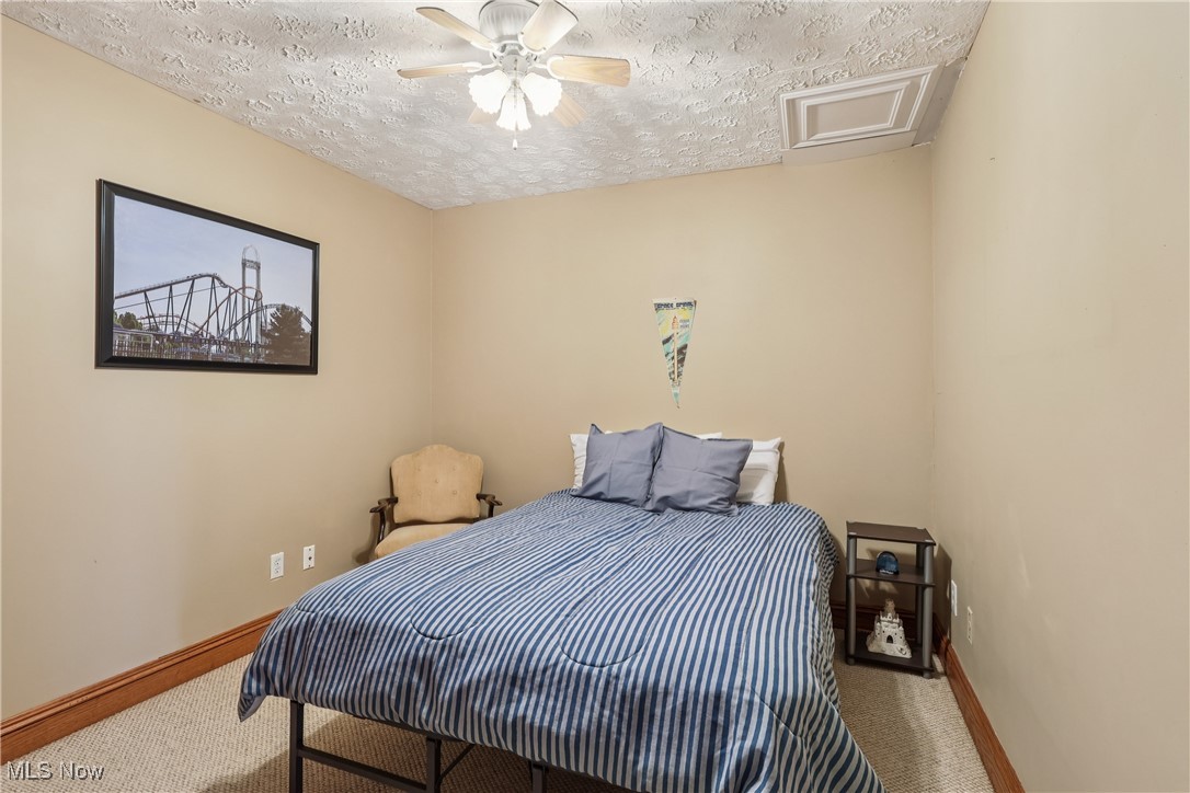 337 Cedar Point Road Sandusky, OH 44870 - Photo 9 of 50 Carpeted bedroom featuring a textured ceiling, attic access, and a ceiling fan
