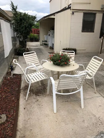 a balcony with table and chairs