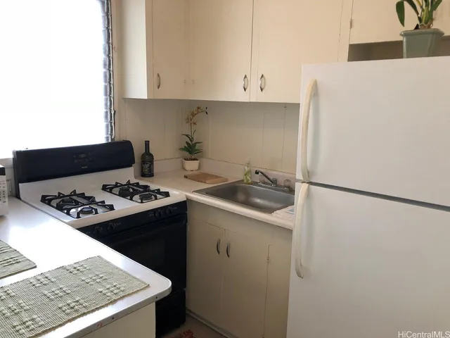 a kitchen with a sink a stove and refrigerator