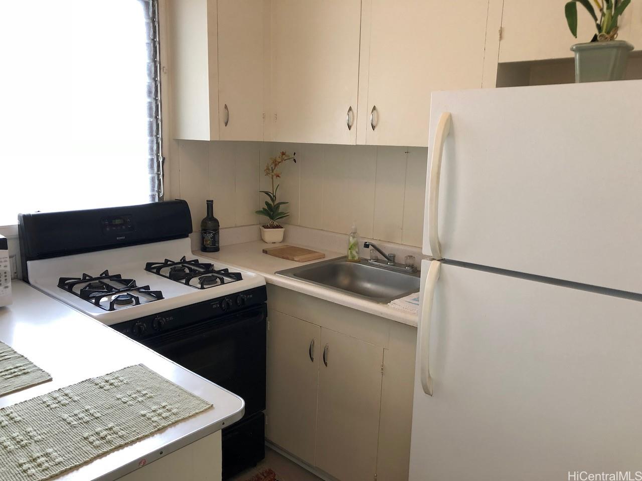 2810 Winam Avenue, Unit B Honolulu, HI 96816 - Photo 3 of 15 a kitchen with a sink a stove and refrigerator