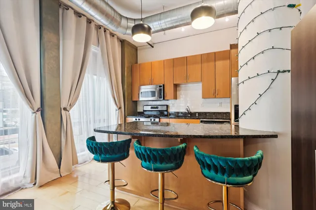 a kitchen with granite countertop a counter space a sink and a window