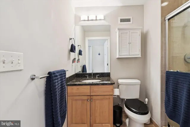 a bathroom with a toilet a sink and a mirror