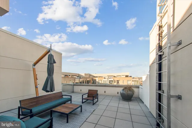 a view of a patio with couches table and chairs and potted plants
