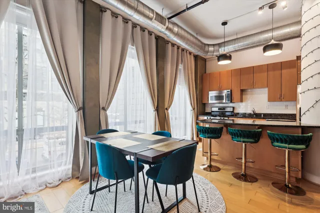 a view of a dining room with furniture and wooden floor