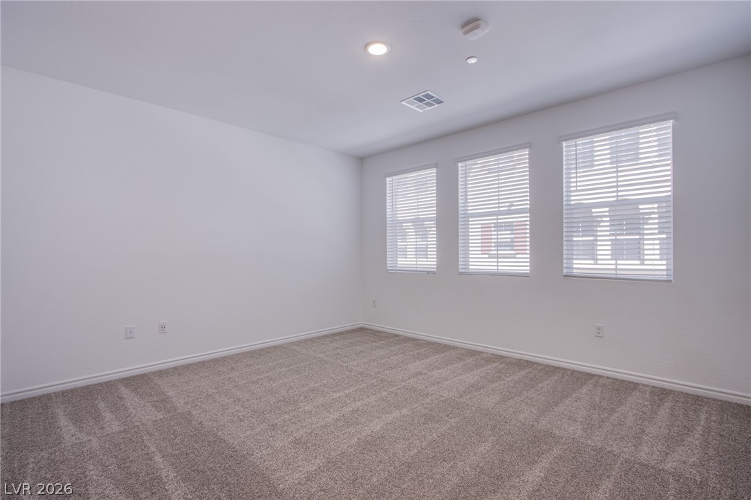 2555 Hampton Road, Unit 8201 Henderson, NV 89052 - Photo 22 of 33 Plush carpeting and abundant natural light define this versatile bedroom space.